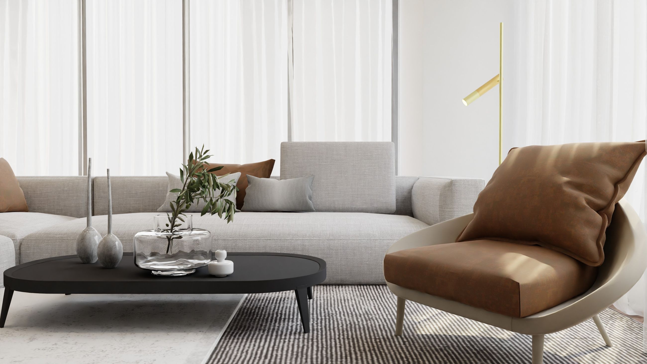 Salon Office Hotel : canapé gris et fauteuil cognac autour d'une table basse, lumière douce
